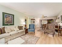 Cozy living room with neutral tones, wood floors, and comfortable seating arrangement at 459 S Boojum Way, Mesa, AZ 85208
