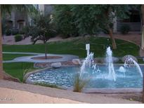 Beautiful water fountain in a community park, surrounded by a grassy area at 5345 E Van Buren St # 167, Phoenix, AZ 85008