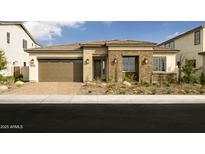 Charming single-story home with desert landscaping, a brick facade and a two car garage, creating an inviting curb appeal at 5719 S Quartz St, Gilbert, AZ 85298