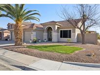 Charming single-story home featuring a well-manicured lawn, desert landscaping and a tile roof at 9 W Glenhaven Dr, Phoenix, AZ 85045