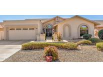 Charming single-story home featuring a low-maintenance front yard and a two-car garage at 9809 W Wescott Dr, Peoria, AZ 85382