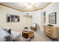 Cozy living room featuring a comfortable sofa, stylish armchair, and decorative elements at 1126 W Elliot Rd # 1024, Chandler, AZ 85224