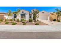 Charming single-story home with a two car garage, landscaped front yard, and neutral color palette at 11807 W Parkway Ln, Avondale, AZ 85323