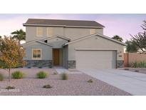 Charming two-story home featuring a two-car garage, stone accents, and drought-tolerant landscaping at 12642 W Parkway Ln, Avondale, AZ 85323