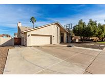 Charming single-story home with neutral stucco, two car garage, and a basketball hoop in the driveway at 1938 E Myrna Ln, Tempe, AZ 85284