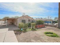 Charming single-story home featuring a stone facade and well-kept front yard at 2237 E Windsor Ave, Phoenix, AZ 85006