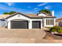 Charming single-story home features a three-car garage and well-manicured landscaping at 328 E Ivy St, Mesa, AZ 85201