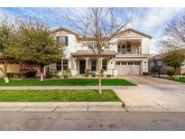 Charming two-story home with a well-manicured lawn and a welcoming front porch showcasing a beautifully landscaped yard at 4226 E Marlene Dr, Gilbert, AZ 85296