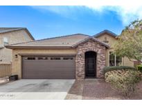 Charming single-story home with a two-car garage, brick accents, and a well-maintained yard at 13225 W Rowel Rd, Peoria, AZ 85383