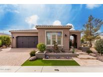 Charming single-story home with well-manicured front yard, desert landscaping, and neutral exterior paint at 1407 E Artemis Trl, San Tan Valley, AZ 85140