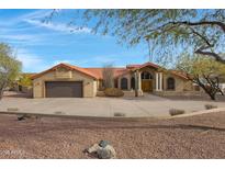 Charming home featuring a tile roof, desert landscaping, and a spacious three car driveway at 16522 E Glenbrook Blvd, Fountain Hills, AZ 85268