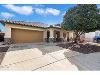 Charming single-story home featuring a tile roof, desert landscaping, covered entryway, and a two car garage at 17201 N Chance Dr, Surprise, AZ 85374