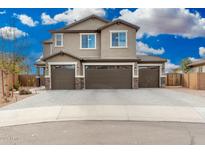 Beautiful two story home featuring three-car garage, landscaped yard and gorgeous windows at 24032 N Rooster Rd, Florence, AZ 85132