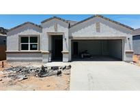 Charming single-story home with a modern design, showcasing its stucco facade and spacious two-car garage at 28228 N Nealite Dr, San Tan Valley, AZ 85143