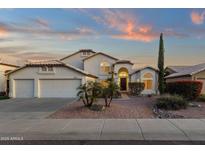 Charming home with a three-car garage, well maintained desert landscaping, and a light beige exterior at 3037 E Bighorn Ave, Phoenix, AZ 85048
