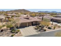 Stunning aerial view of a home with well-manicured desert landscaping and a three car garage at 31085 N 72Nd Pl, Scottsdale, AZ 85266