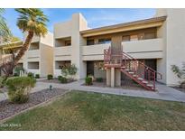 Inviting condo exterior with well-maintained landscaping, stairs and desert foliage at 3301 E Earll Dr # 210, Phoenix, AZ 85018