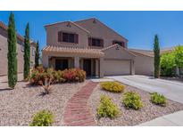 Charming two-story home with a well-maintained desert-style front yard and walkway at 5445 S 239Th Dr, Buckeye, AZ 85326