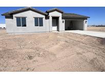 Charming single-story home featuring an attached two-car garage and well-lit entryway at 6274 S Dean Rd, Buckeye, AZ 85326