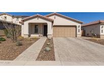 Charming single-Gathering home with a well-manicured front yard and a neutral-toned color palette at 7442 W Redbird Rd, Peoria, AZ 85383