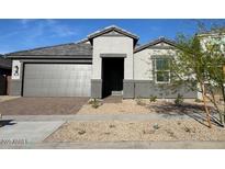 Charming single-story home featuring neutral colors, a two-car garage, and low maintenance front yard at 10039 S 23Rd Dr, Phoenix, AZ 85041