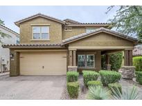 Charming two-story home with a well-manicured lawn and a two-car garage at 10249 E Kinetic Dr, Mesa, AZ 85212