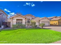 Charming single-Gathering home with a well-manicured front lawn, desert landscaping, and a two-car garage at 1086 S Western Skies Dr, Gilbert, AZ 85296