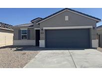 Charming single-story home featuring a spacious driveway and a modern two-car garage at 1361 W Hess Ave, Coolidge, AZ 85128