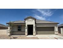 Charming single-story home with stone accents, a two-car garage, and a well-manicured front yard at 1404 W Kennedy Ave, Coolidge, AZ 85128