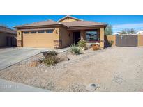 Inviting single-story home with desert landscaping, a two-car garage, and a cozy front porch at 23882 W Yavapi St, Buckeye, AZ 85326