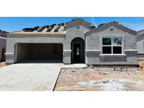 New home construction with a gray stucco exterior, a garage and stacked roof tiles at 28216 N Nealite Dr, San Tan Valley, AZ 85143