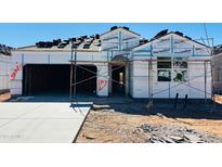 Under construction home featuring a two-car garage and a tile roof being installed at 28216 N Nealite Dr, San Tan Valley, AZ 85143
