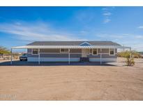 Charming single-story home featuring a covered parking area and desert landscaping at 31555 N Royce Rd, San Tan Valley, AZ 85144