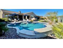 Beautiful backyard pool with seating area and outdoor kitchen, perfect for entertaining guests at 31709 N 16Th Ave, Phoenix, AZ 85085