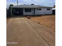 Charming single-story home with a covered carport and a well-maintained front yard at 3321 E Culver St, Phoenix, AZ 85008