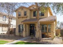 Inviting two-story home featuring a charming front porch, neutral color palette and drought tolerant landscaping at 3840 E Yeager Dr, Gilbert, AZ 85295