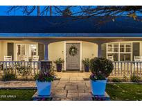 Inviting front entrance featuring a gray front door with a wreath, stone pathway, and beautiful planters at 4111 N 52Nd St, Phoenix, AZ 85018