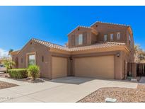 Charming one-story home featuring a well-maintained yard with mature landscaping and a two-car garage at 4376 S Summit St, Gilbert, AZ 85297