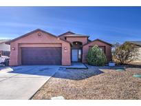 Charming single-story home with a well-maintained front yard and attached two-car garage at 5071 W Warren Dr, Casa Grande, AZ 85194