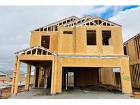 New construction shows the exterior framing of a two-story home with a garage, under a cloudy sky at 5106 E Umber Rd, San Tan Valley, AZ 85143