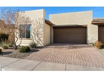 Modern home featuring a two-car garage and a brick paver driveway enhanced by desert landscaping at 678 E Cobble Stone Dr, Queen Creek, AZ 85140