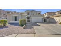 Charming single Gathering home featuring a 2-car garage and low maintenance desert landscaping at 10343 E Jacob Ave, Mesa, AZ 85209