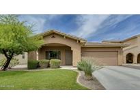 Charming single-story home featuring a well-maintained lawn, a two-car garage, and appealing desert landscaping at 1066 E Sourwood Dr, Gilbert, AZ 85298