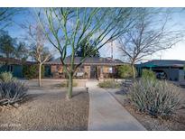 Charming home with desert landscaping, a tile roof, and a welcoming front porch at 1261 E Edgemont Ave, Phoenix, AZ 85006