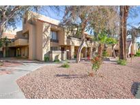 Inviting condo exterior featuring manicured landscaping and pathways to each unit at 1432 W Emerald Ave # 742, Mesa, AZ 85202