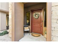 Inviting front entrance with a decorative wreath, stylish door, and charming outdoor seating area at 27000 N Alma School Pkwy # 2019, Scottsdale, AZ 85262