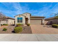 Charming single-story home featuring a low-maintenance front yard and a brick-paved driveway leading to a two-car garage at 287 N Jesse St, Chandler, AZ 85225