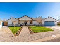 Charming single-story home with well-manicured lawn and brick pathway leading to the inviting front entrance at 3312 E Sells Dr, Phoenix, AZ 85018