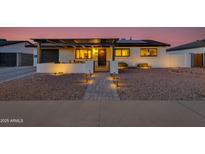 Charming single-story home featuring desert landscaping, pergola, and inviting pathway leading to the front door at 3350 W Charter Oak Rd, Phoenix, AZ 85029