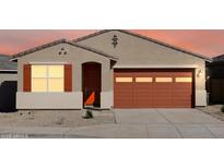 A charming single-Gathering home featuring a desert front yard, an orange garage door and complementary shutters at 37056 W Prado St, Maricopa, AZ 85138